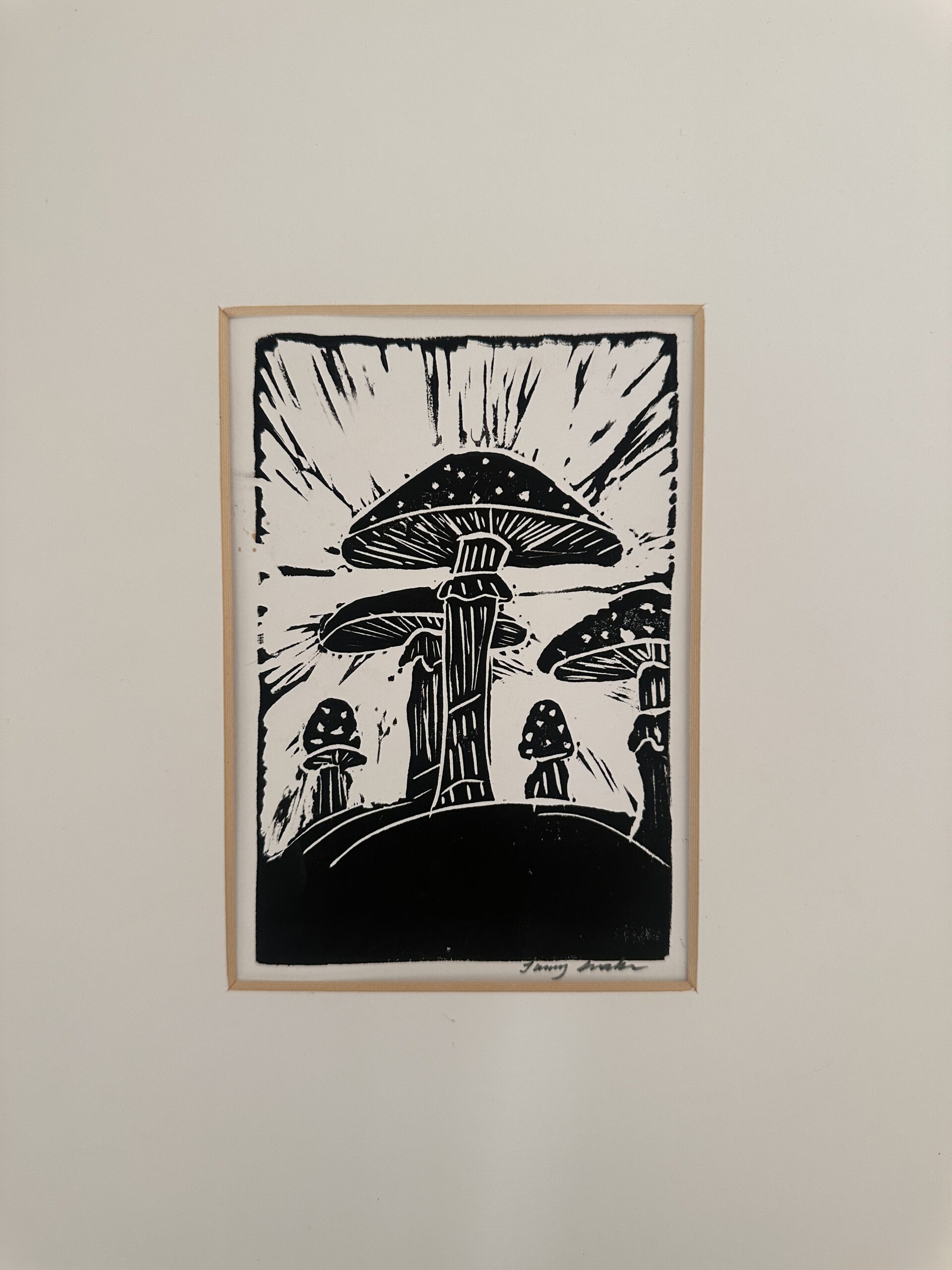 Mycelium Dreams, linocut of mushrooms against radiating light