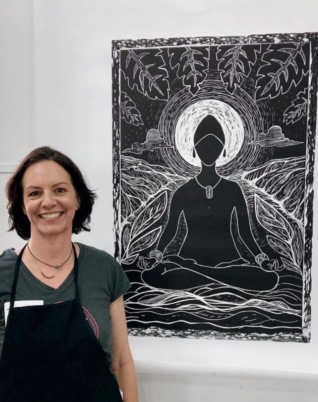 Tammy Swahn Cleland beside her woodblock print Still, I Shine